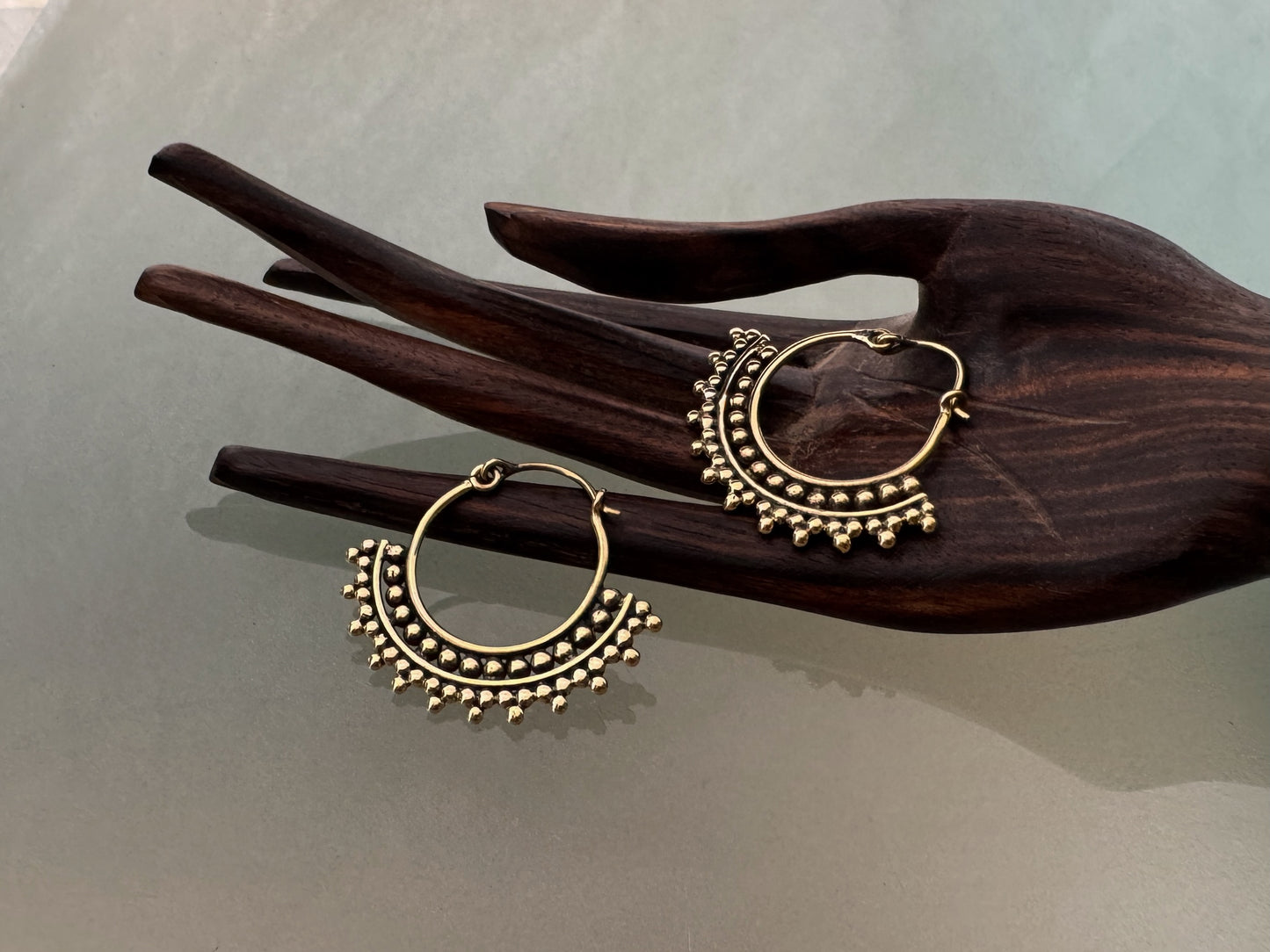 large spiral earrings with zigzag pattern made of brass