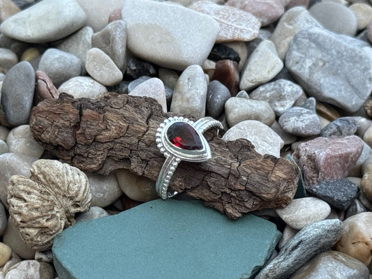 Ring mit facettiertem Granat in Tropfenform aus Silber