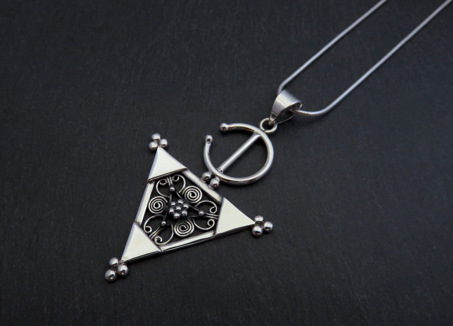 Pendant with a filigree decorated triangle made of silver