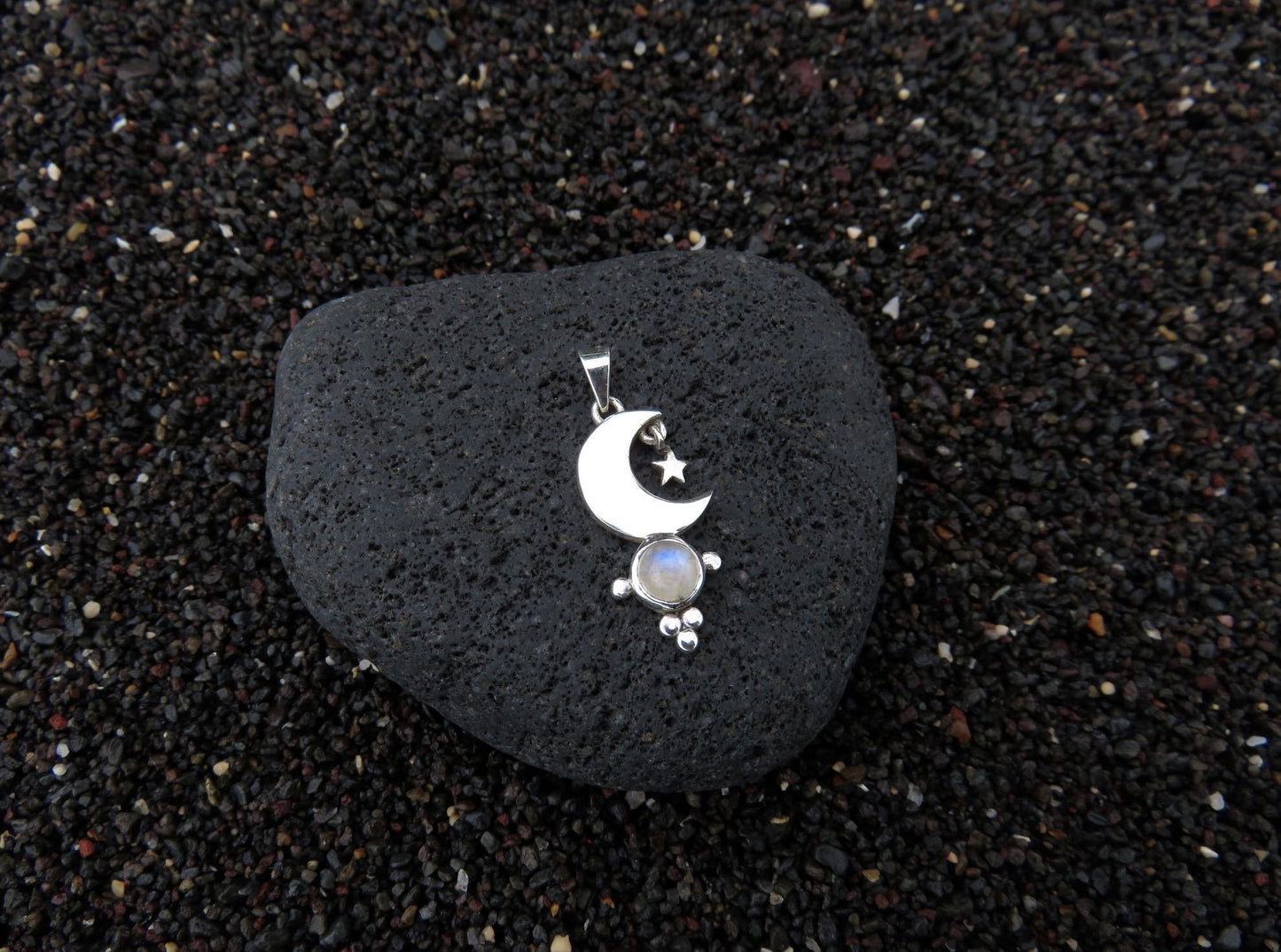 small pendant with moon and stars on a silver ball chain