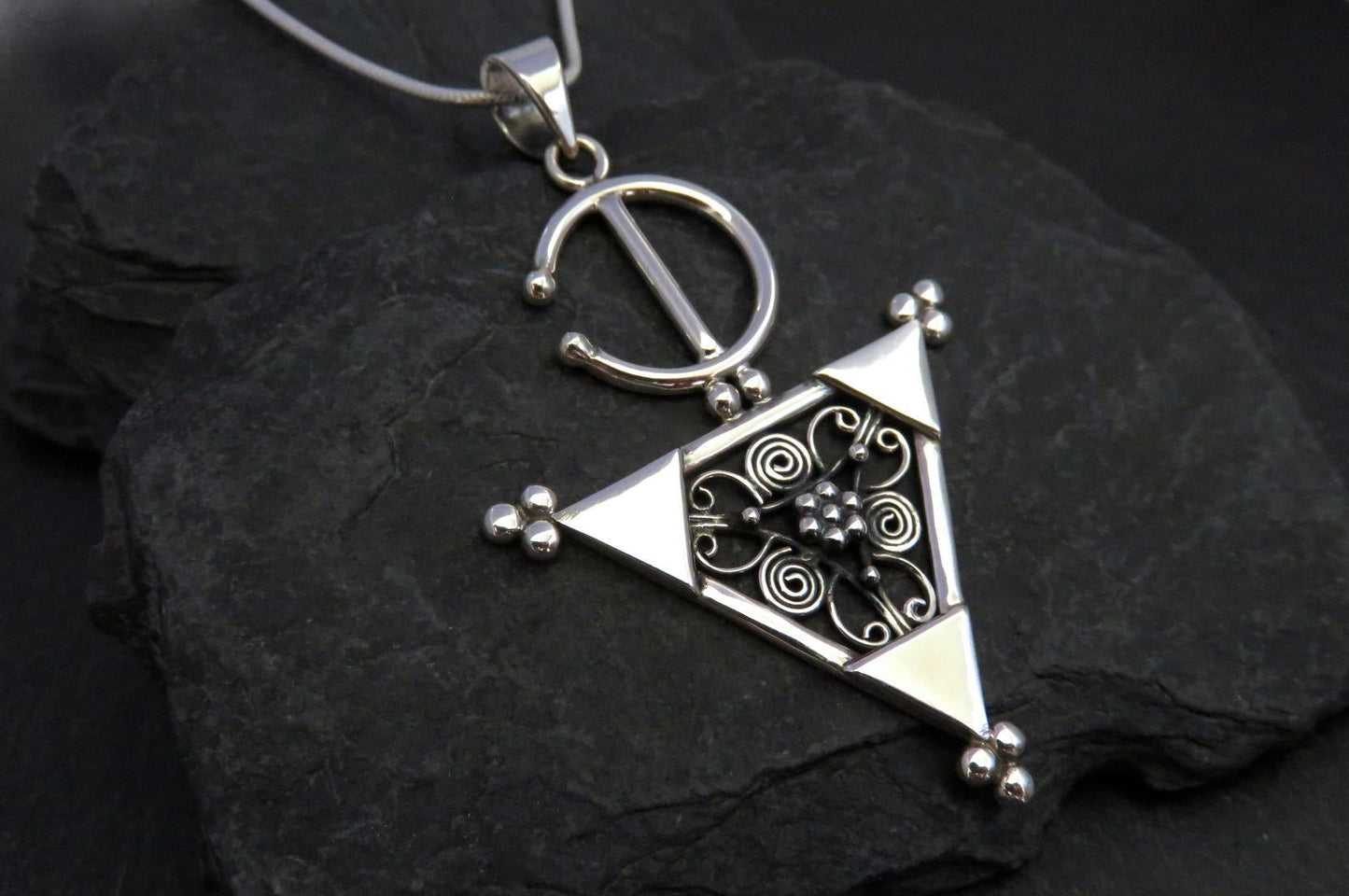 Pendant with a filigree decorated triangle made of silver