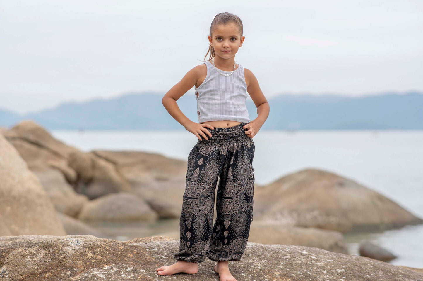 Airy black harem pants with a delicate pattern for children