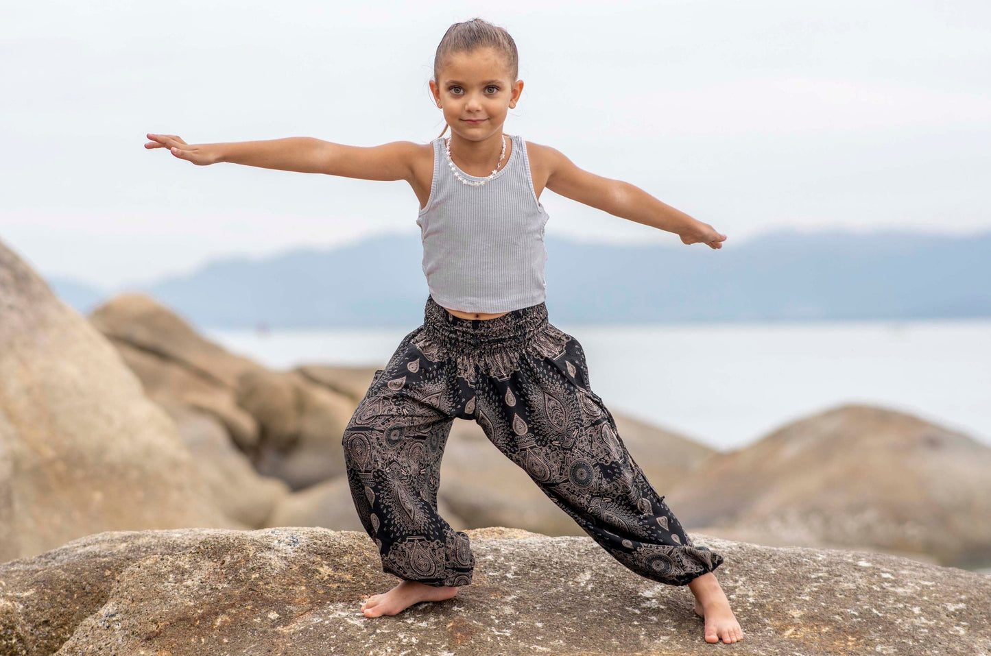 Airy black harem pants with a delicate pattern for children