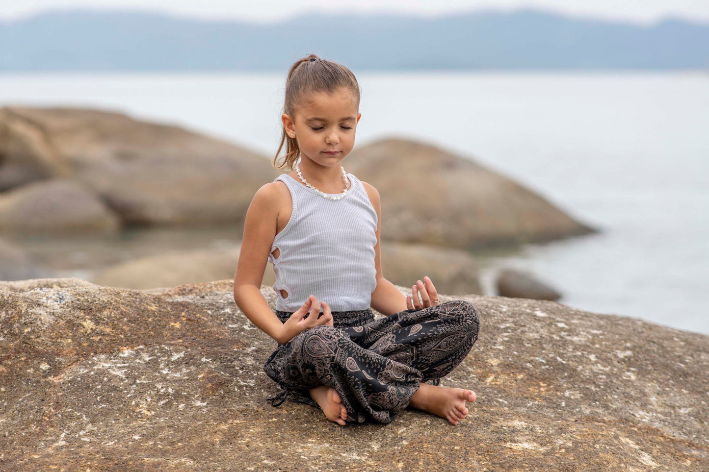 Airy black harem pants with a delicate pattern for children