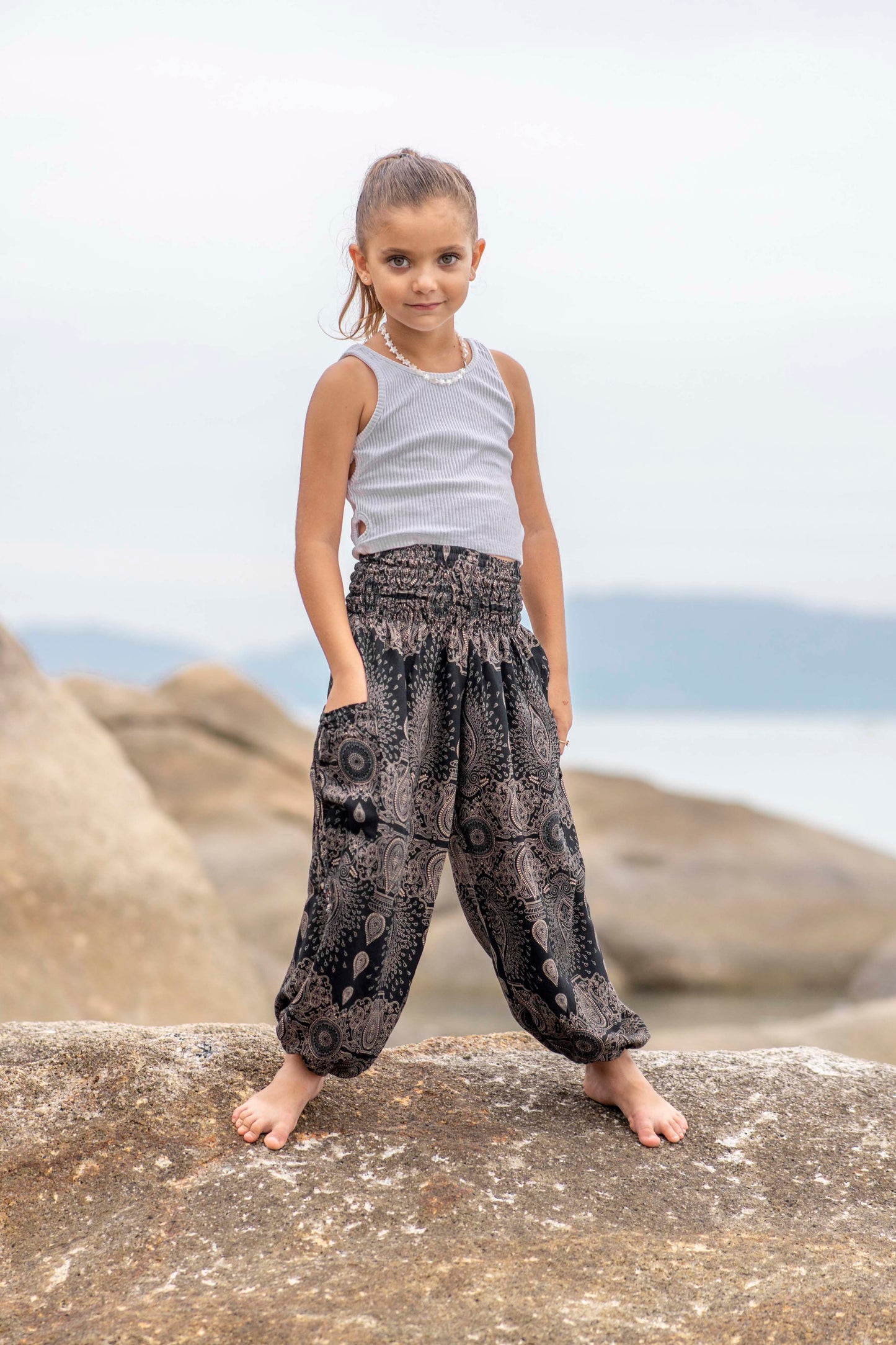 Airy black harem pants with a delicate pattern for children