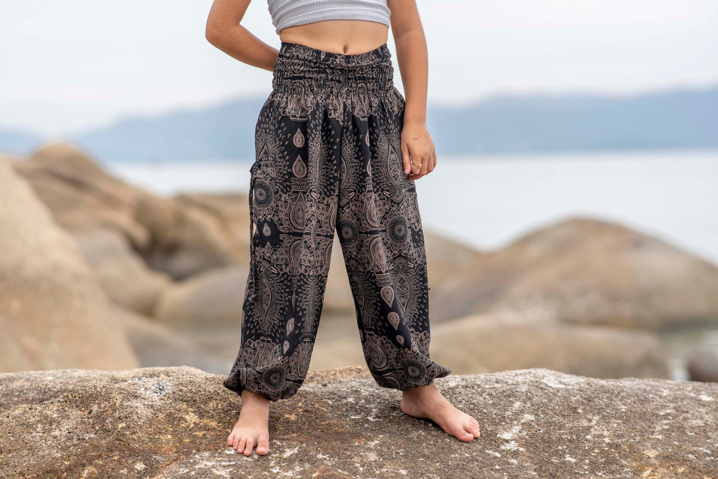 Airy black harem pants with a delicate pattern for children