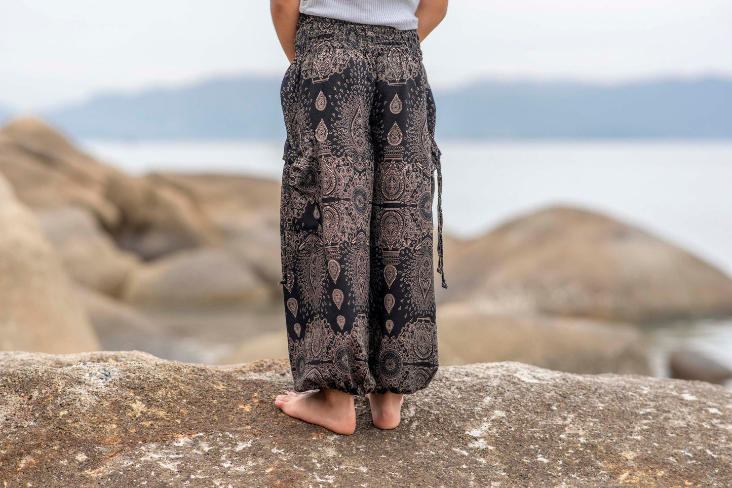 Airy black harem pants with a delicate pattern for children