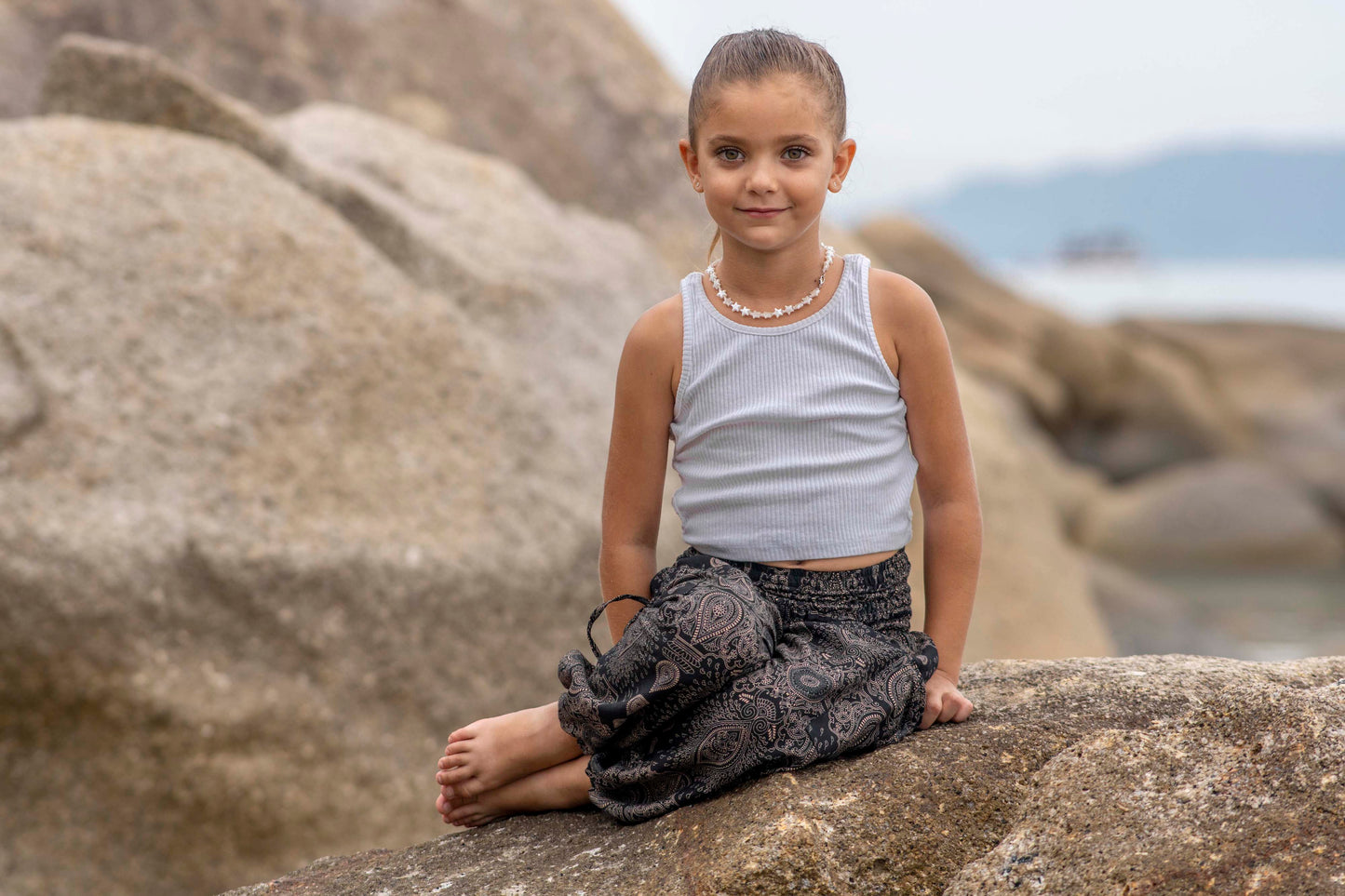Airy black harem pants with a delicate pattern for children