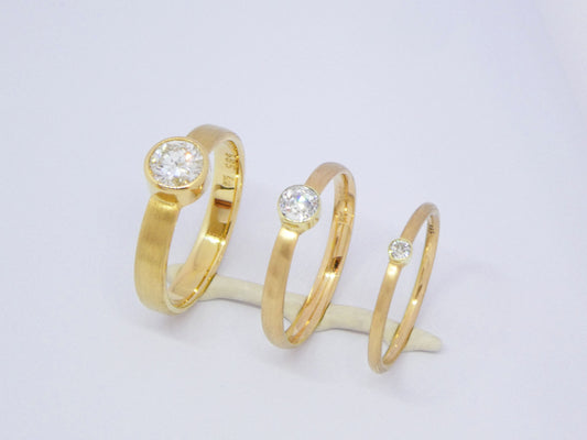 narrow handcrafted gold ring with diamond