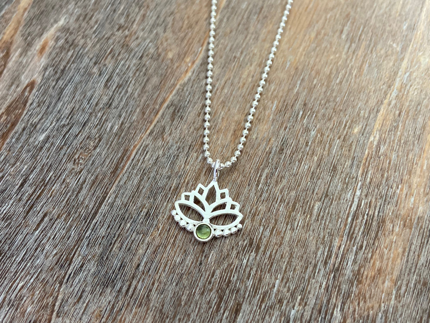 Lotus flower pendant with peridot stone and silver dots