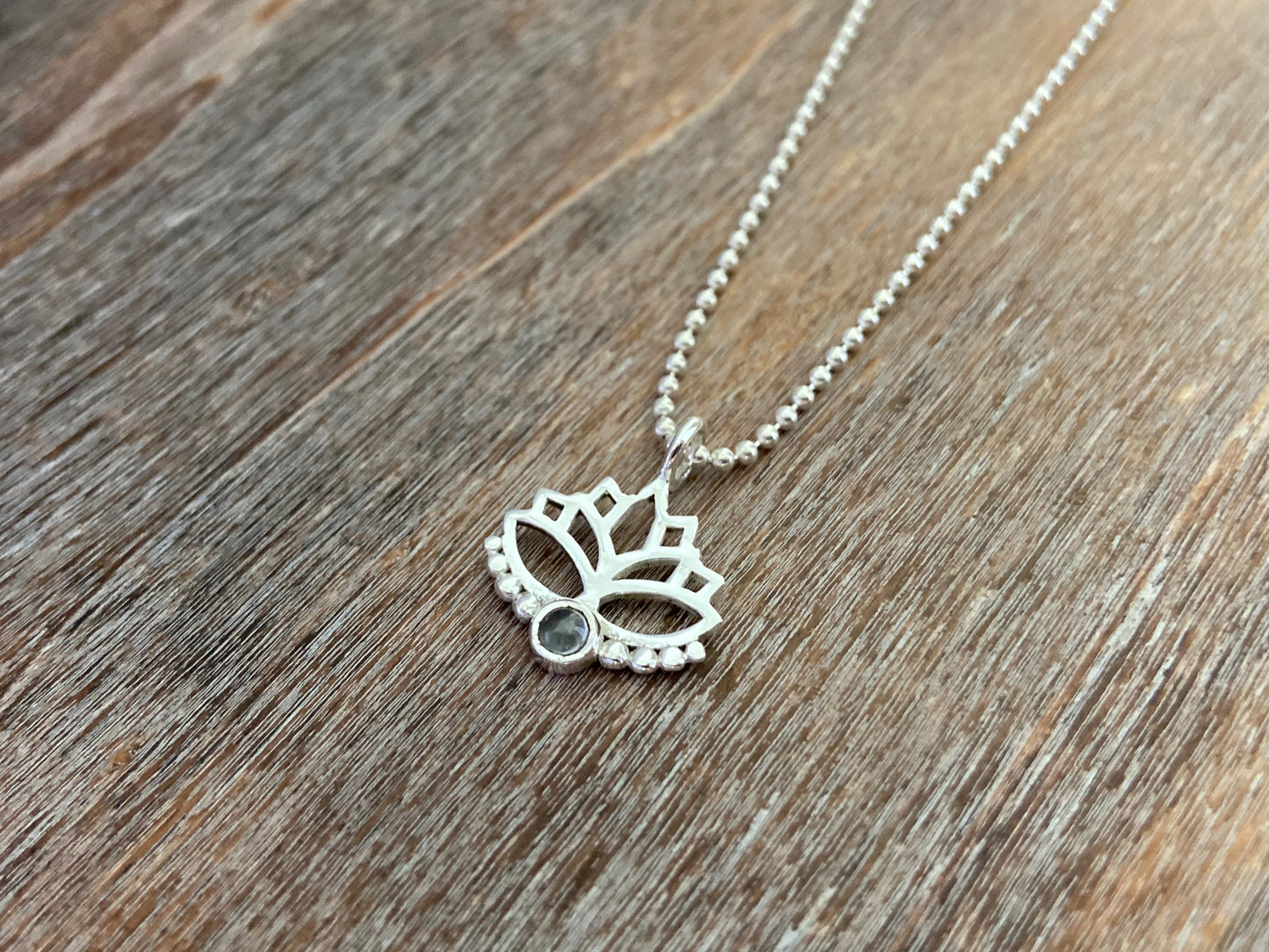 Lotus flower pendant with blue topaz stone and silver dots