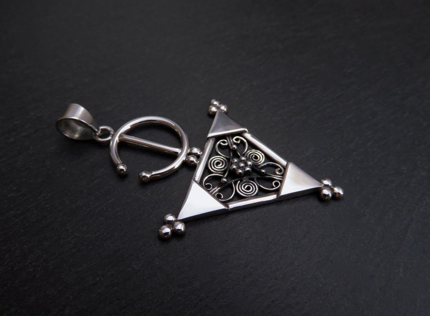 Pendant with a filigree decorated triangle made of silver