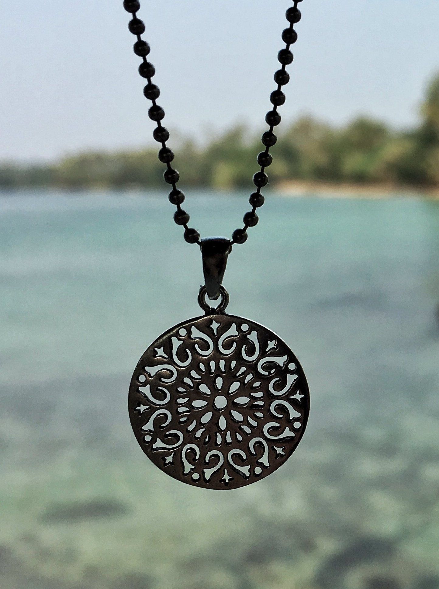 small round pendant on a silver ball chain