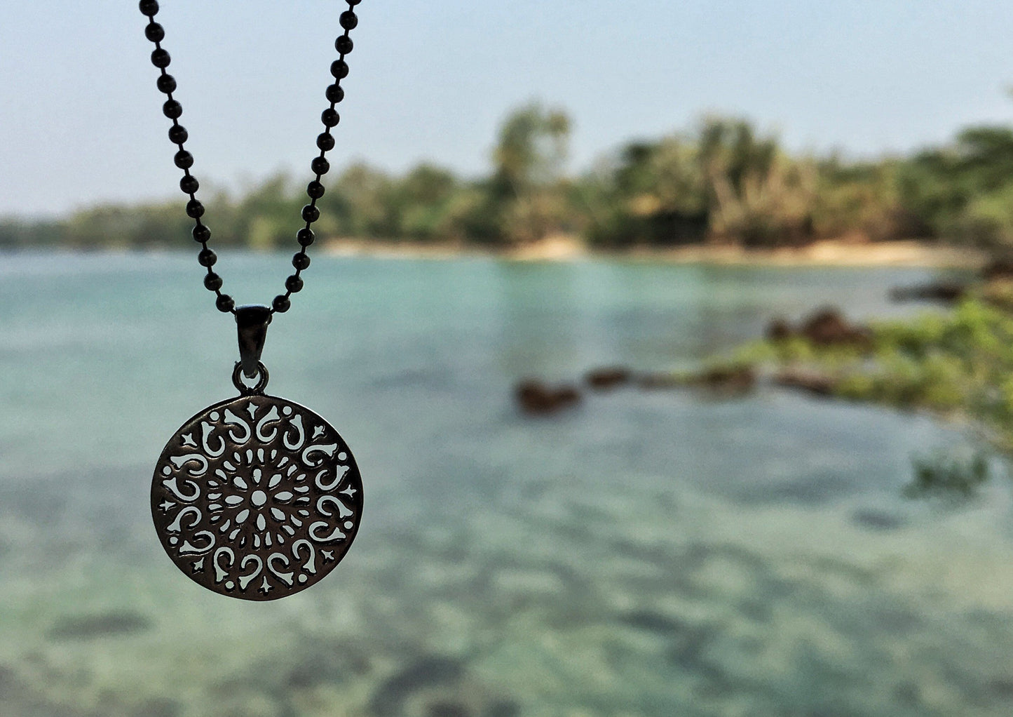 small round pendant on a silver ball chain