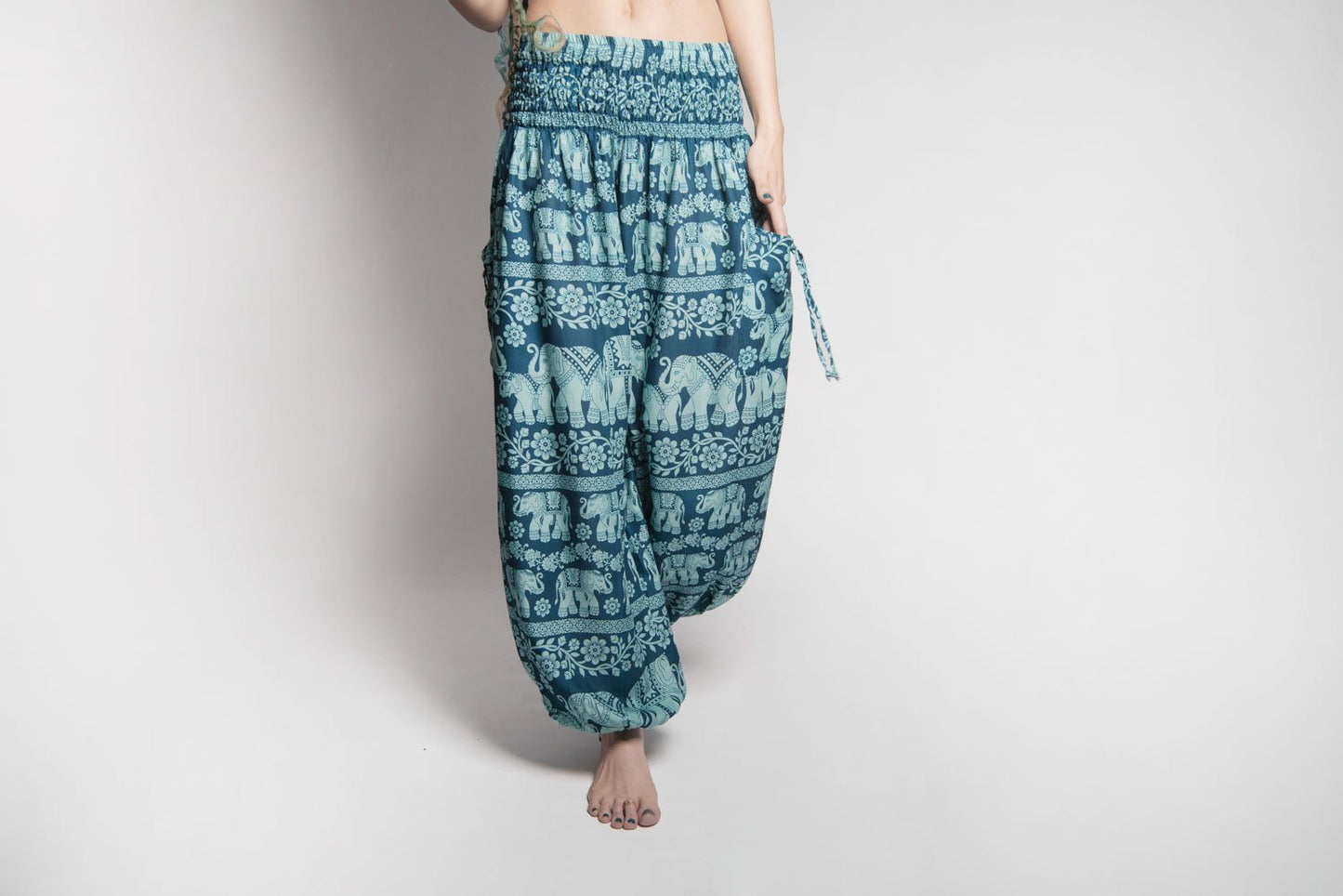 Airy harem pants with an elephant pattern in turquoise with pockets