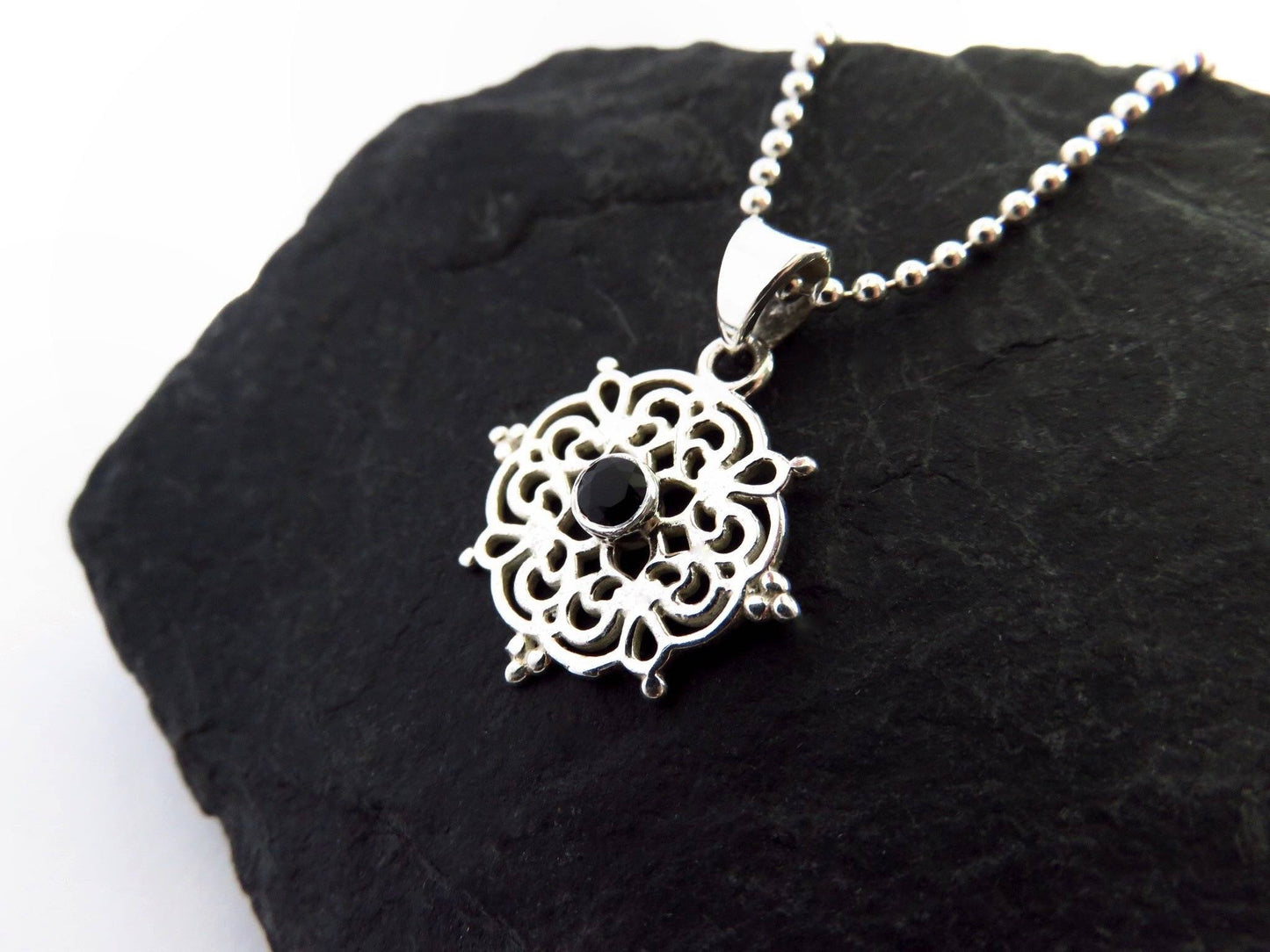 small filigree pendant with black spinel made of silver