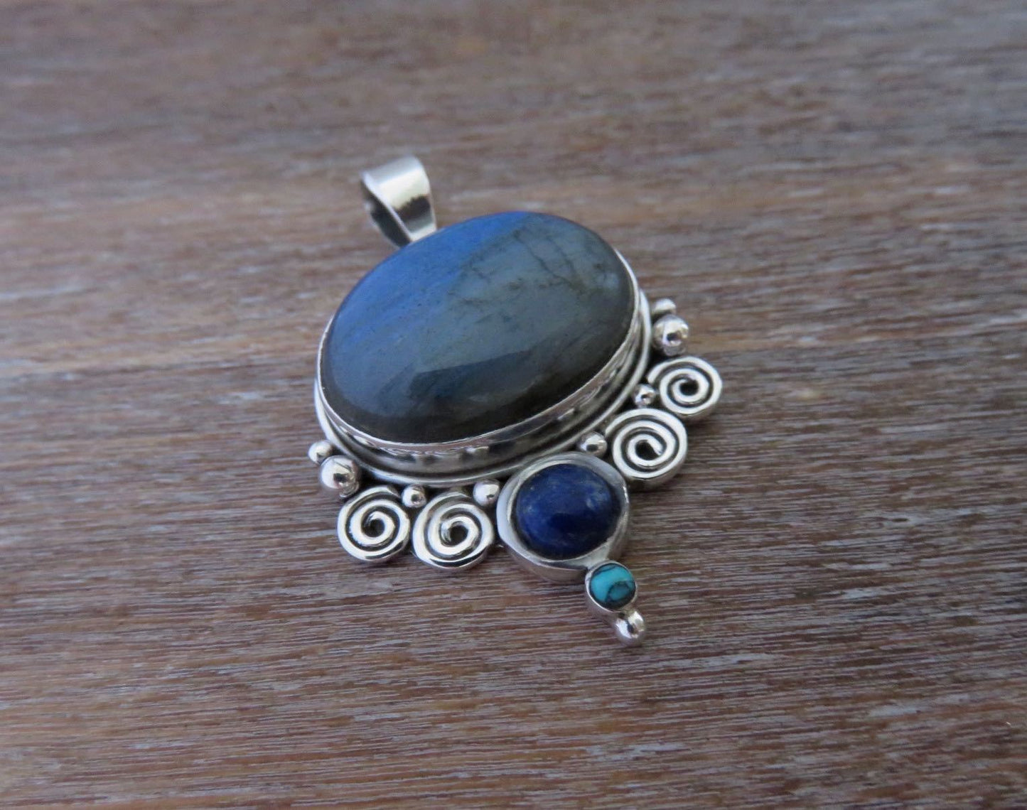 Pendant with spirals and stones made of silver