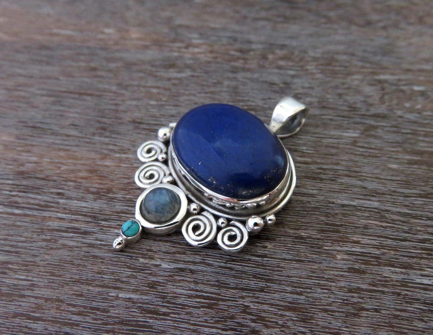 Pendant with spirals and stones made of silver
