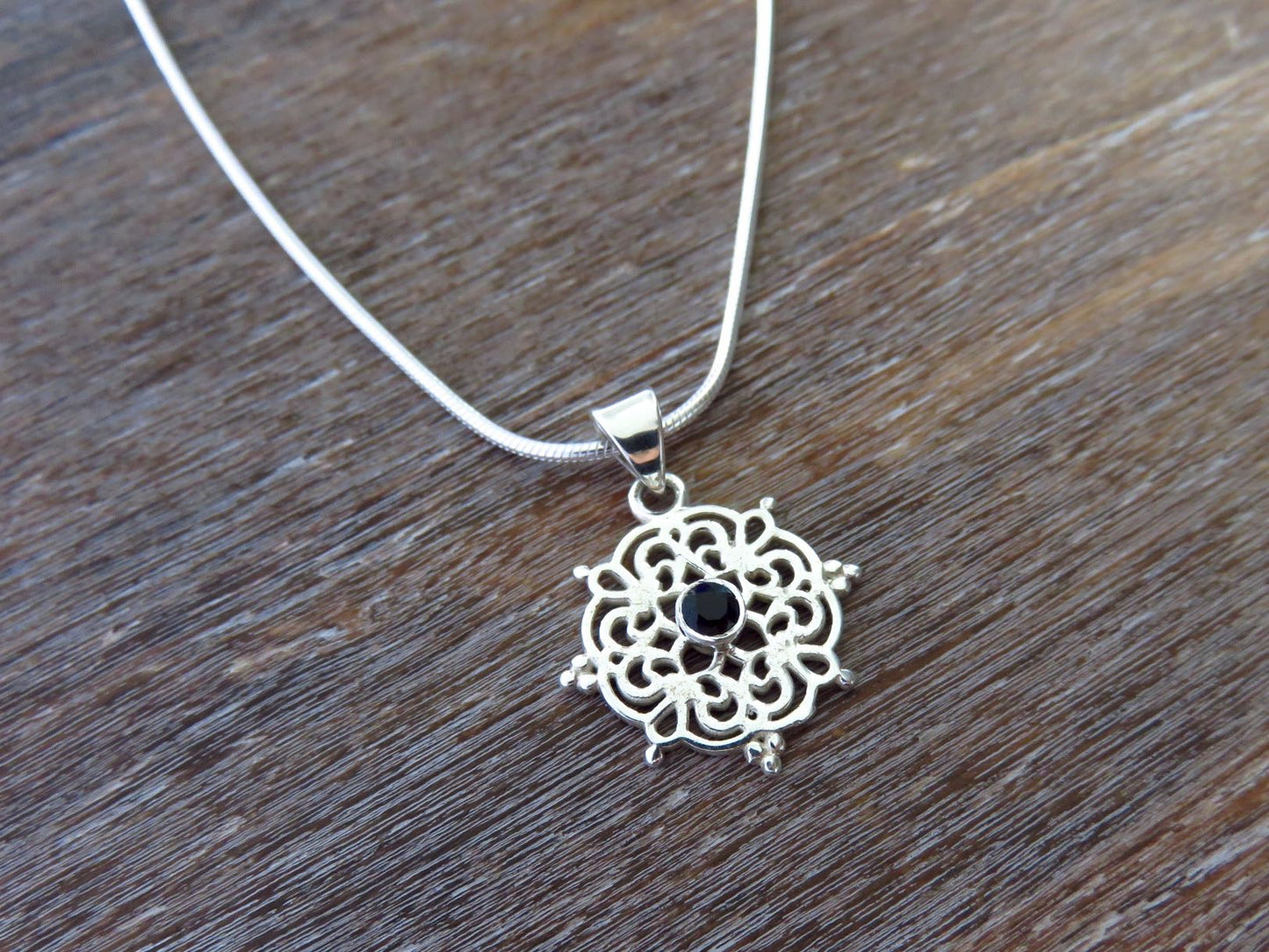 small filigree pendant with black spinel made of silver