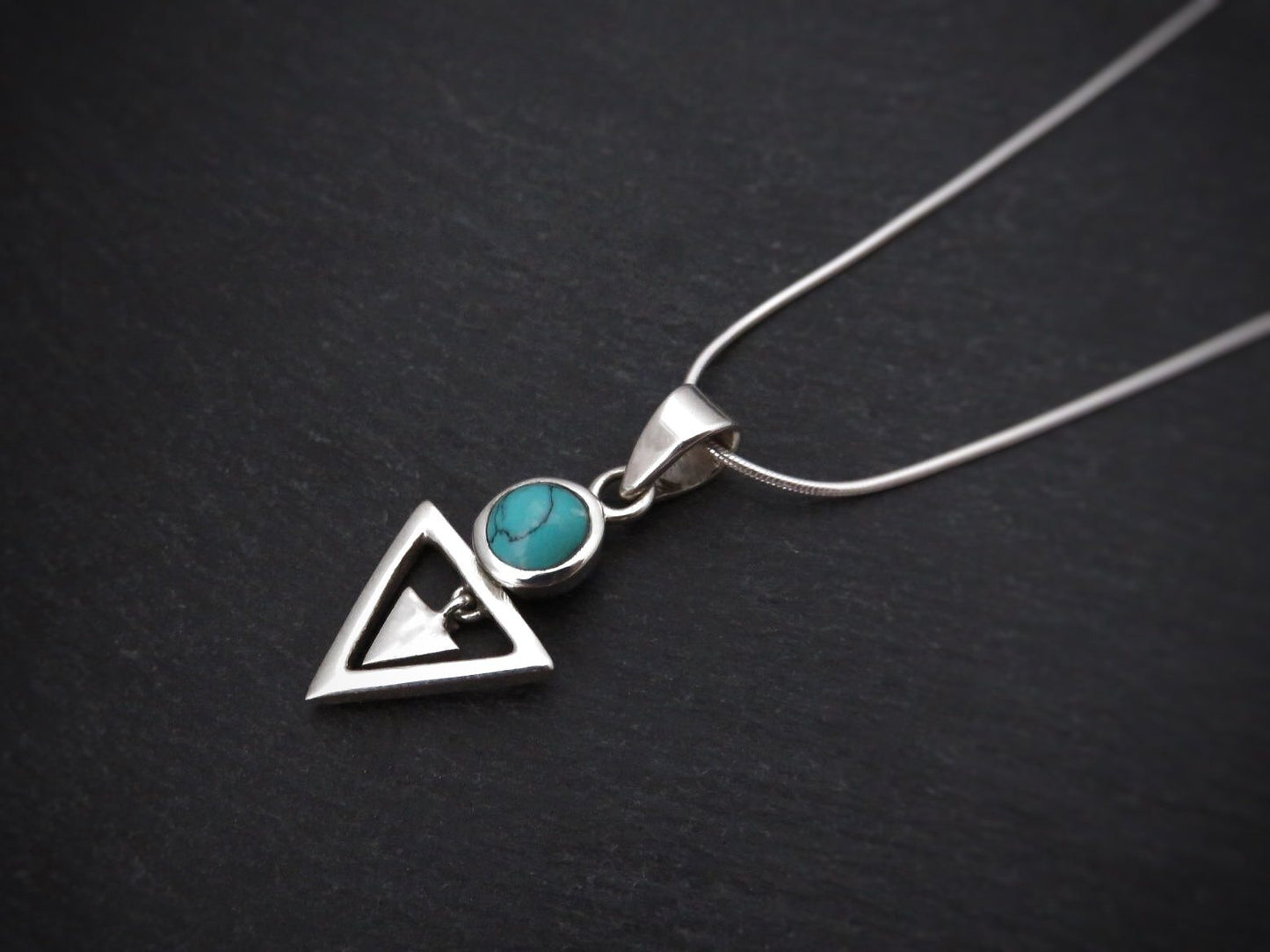 Pendant with stone and small dangling triangle