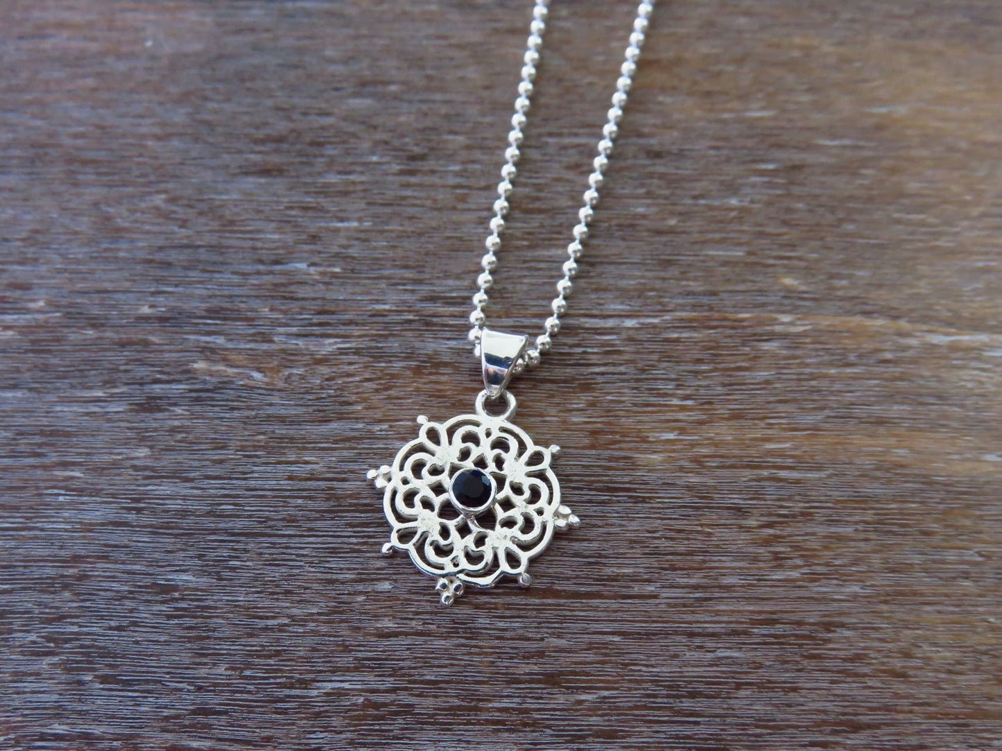 small filigree pendant with black spinel made of silver