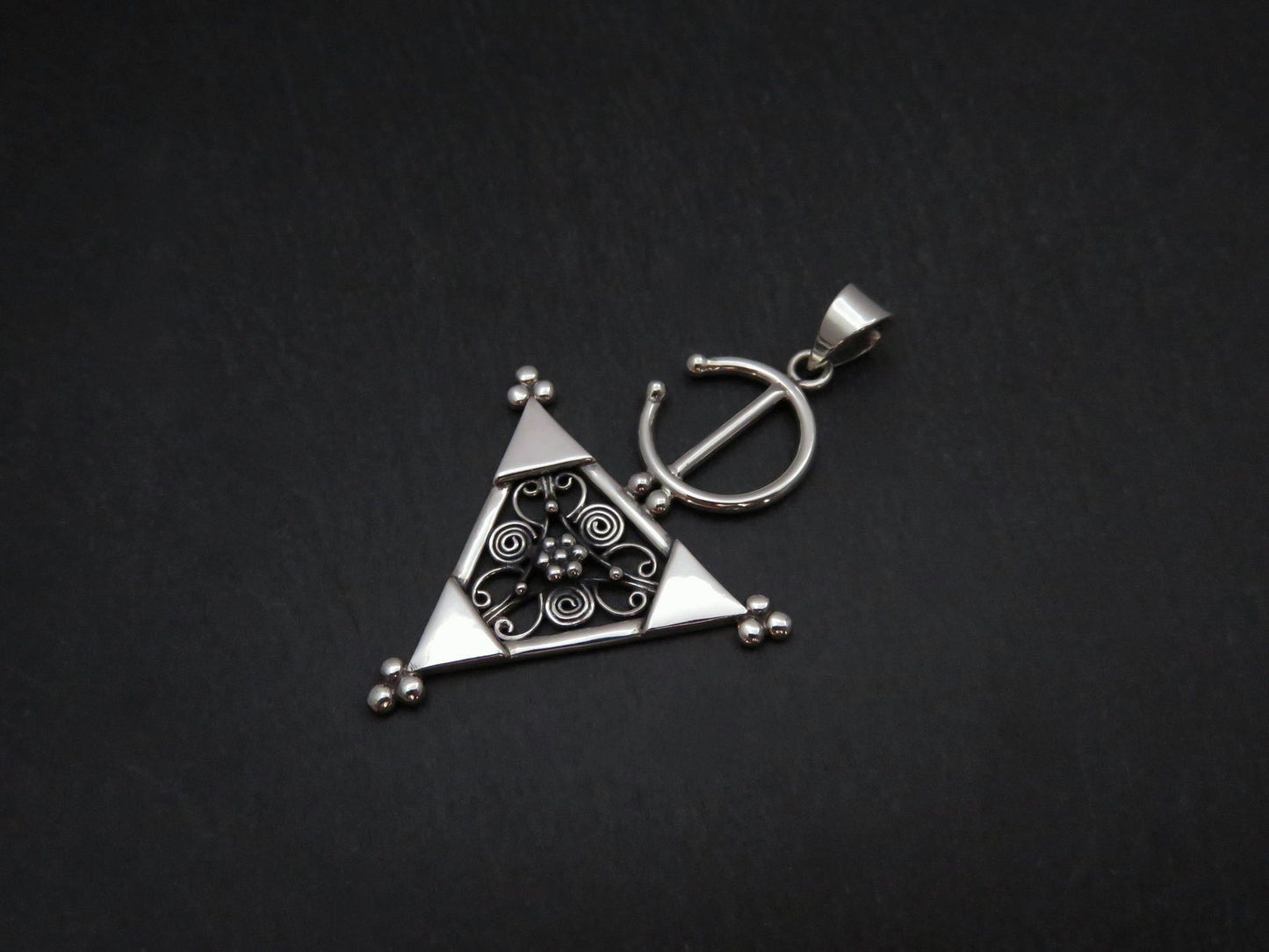 Pendant with a filigree decorated triangle made of silver