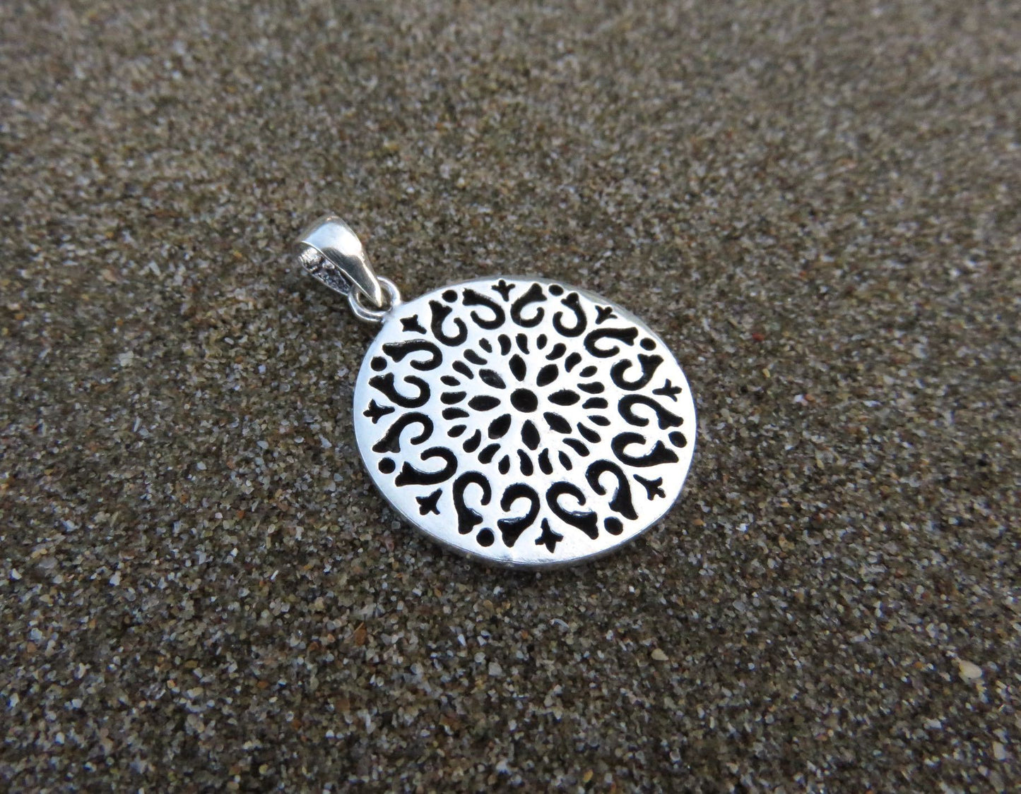 small round pendant on a silver ball chain