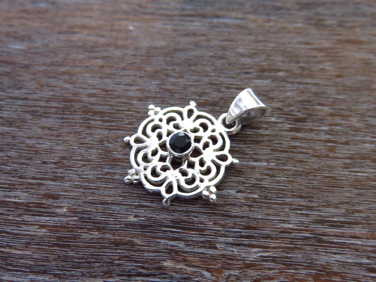 small filigree pendant with black spinel made of silver
