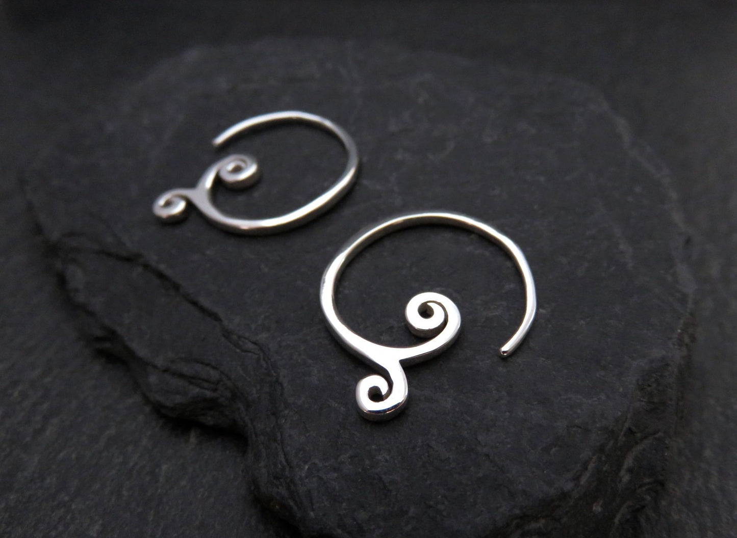 simple small earrings with spirals made of silver