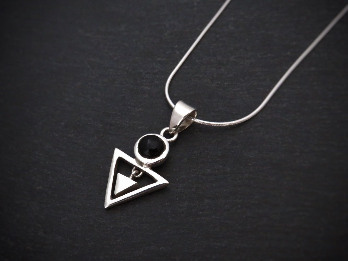Pendant with stone and small dangling triangle