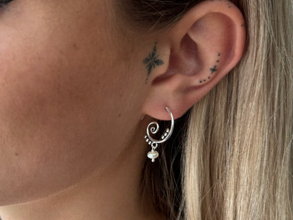 Silver hoop earrings with dangling tourmaline stones 