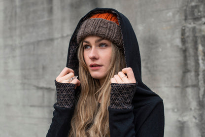 long knitted sweater with a patterned hood and thumbholes in black 