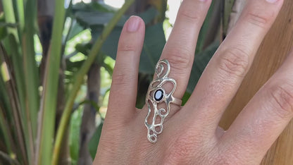 Ornate silver ring with spirals and black stone 