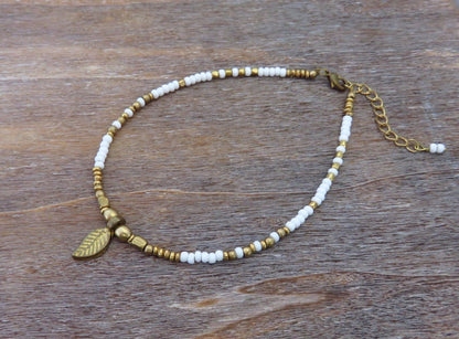 Anklet with small brass leaf and colored beads 