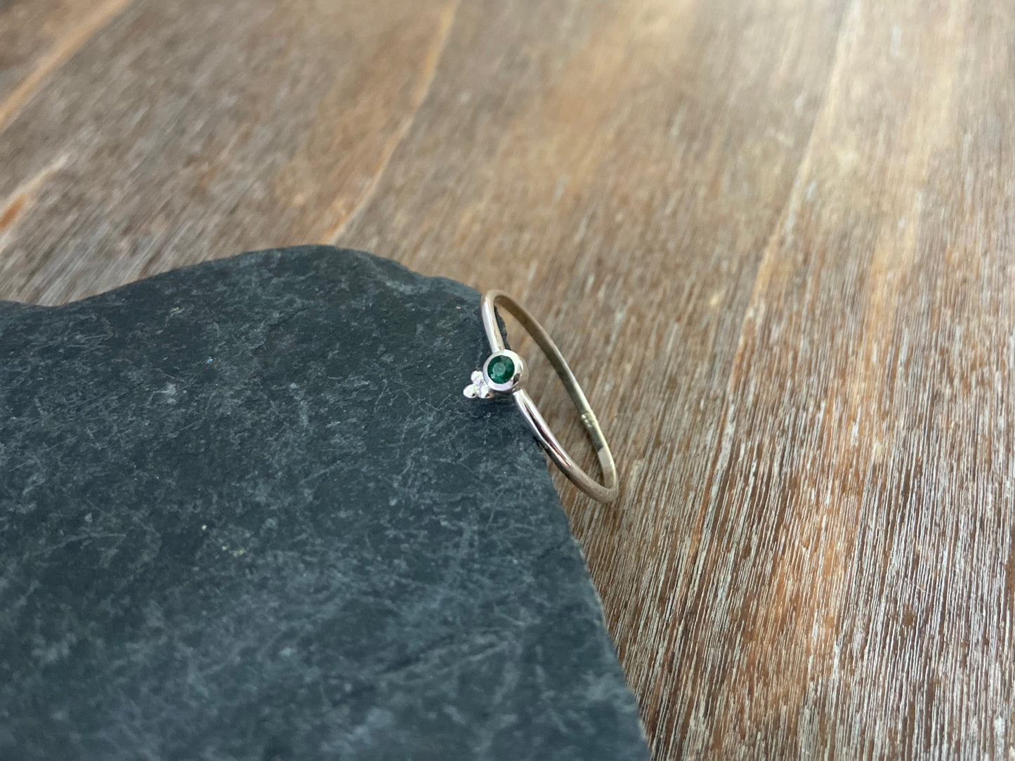 Dainty silver ring with a small faceted green emerald stone and three beads 