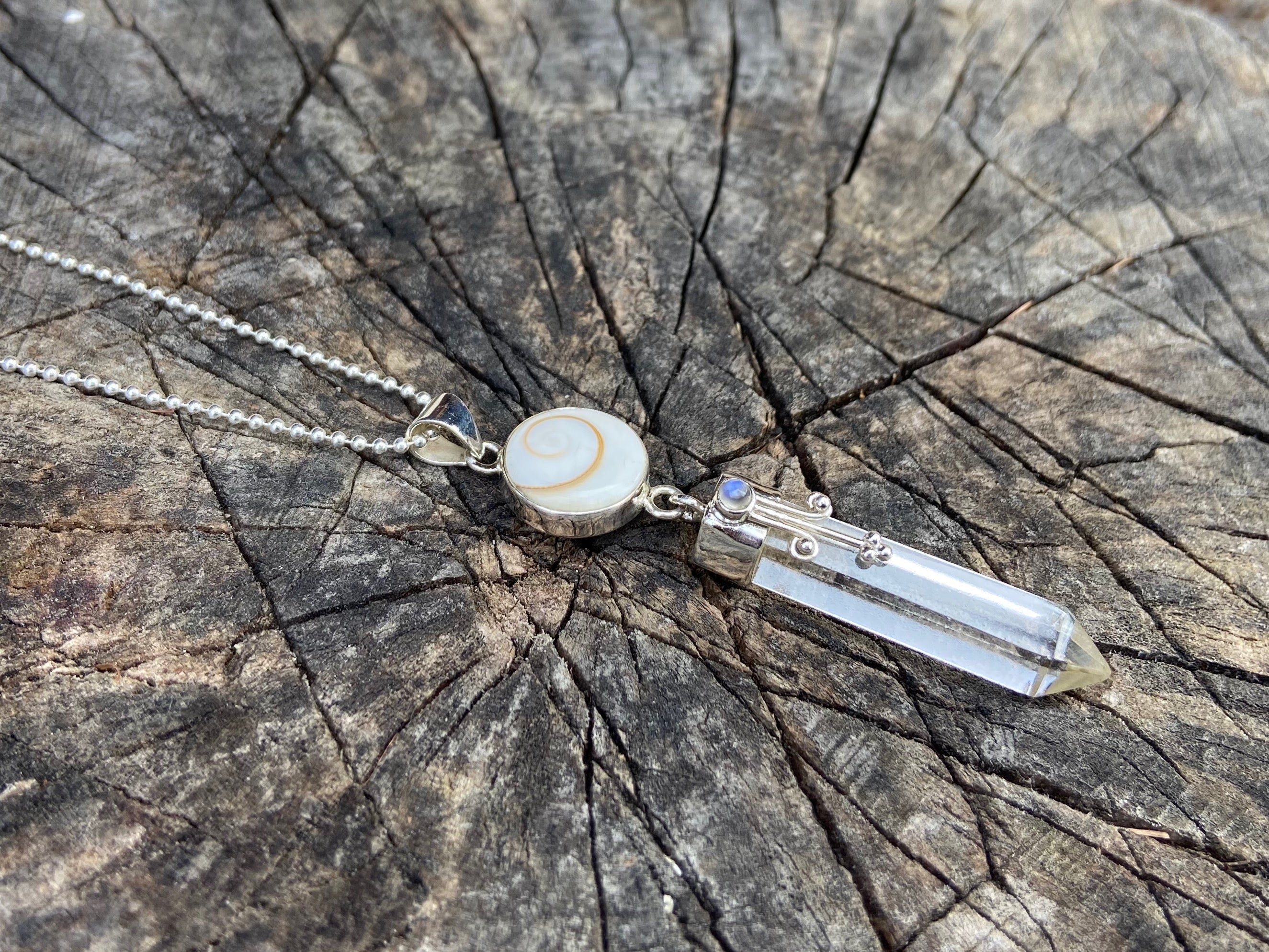 Pendant rock crystal with operculum with spirals, dots and small stone ...