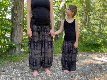 Airy black harem pants with a delicate pattern for children 