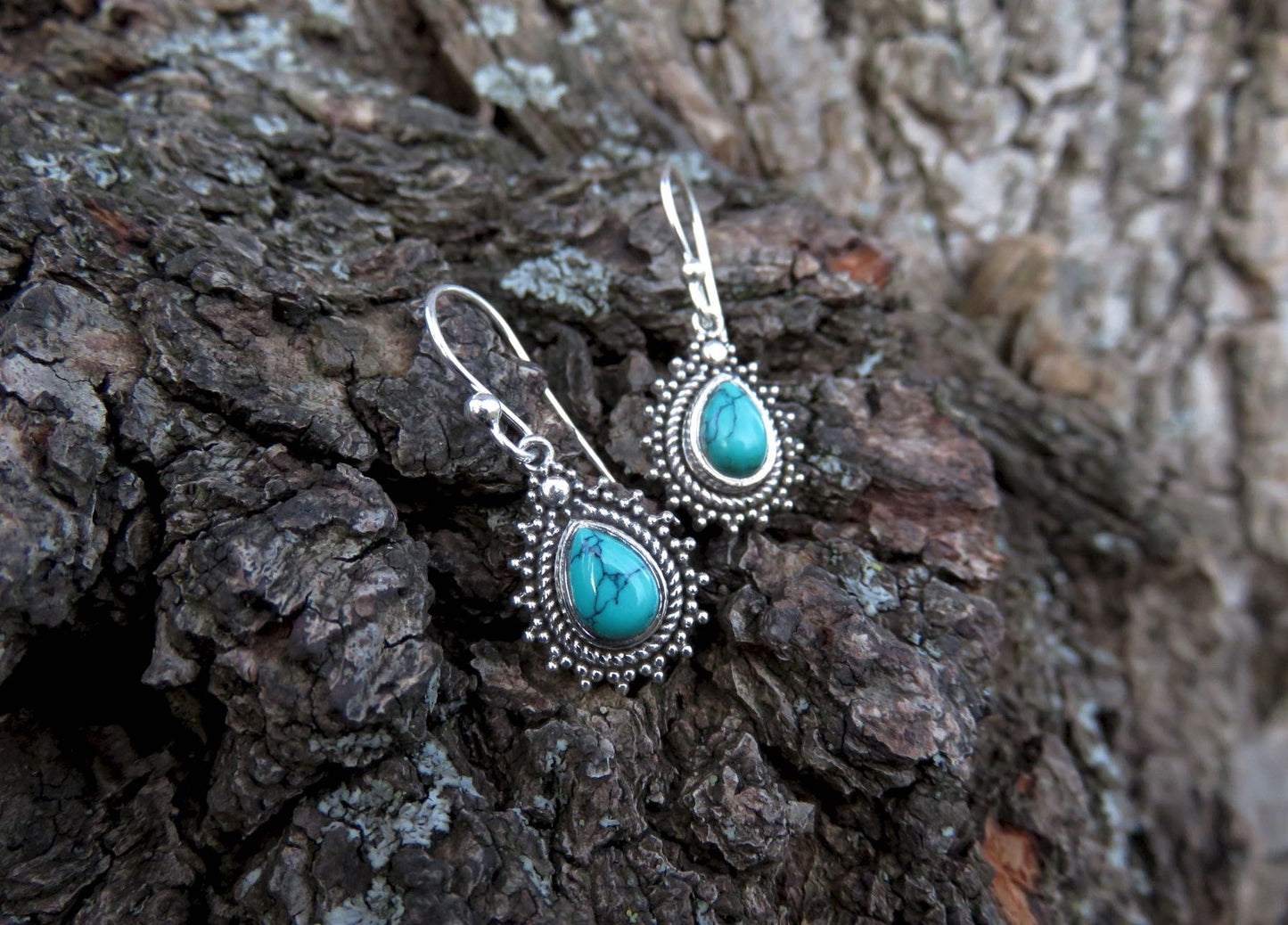 small earrings made of silver with a drop-shaped stone 