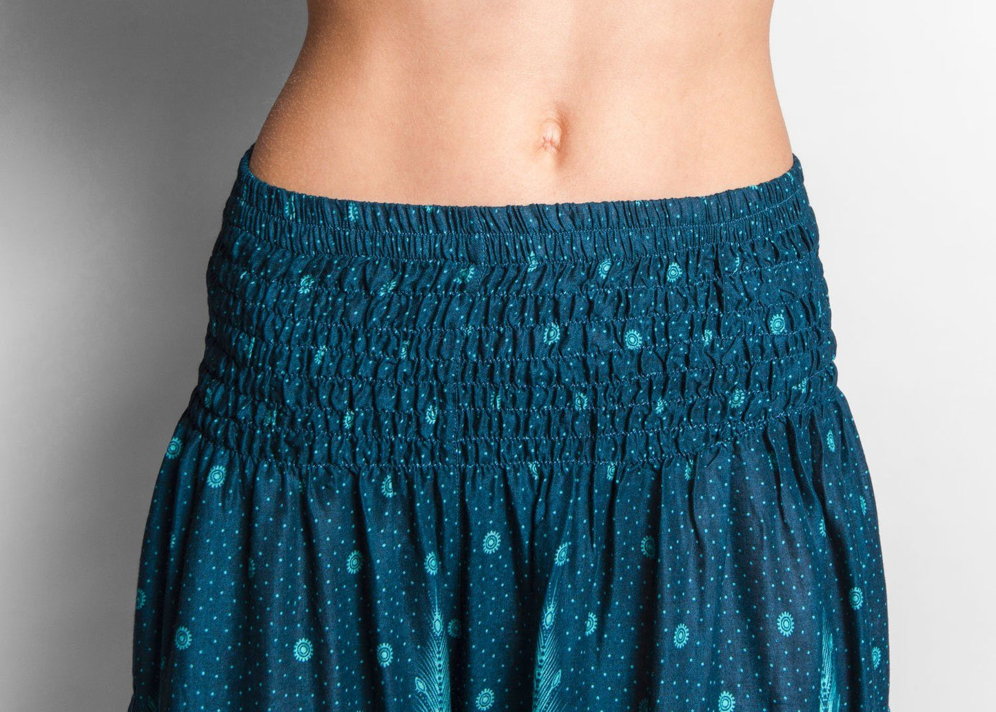 Airy harem pants with a peacock pattern in turquoise with pockets