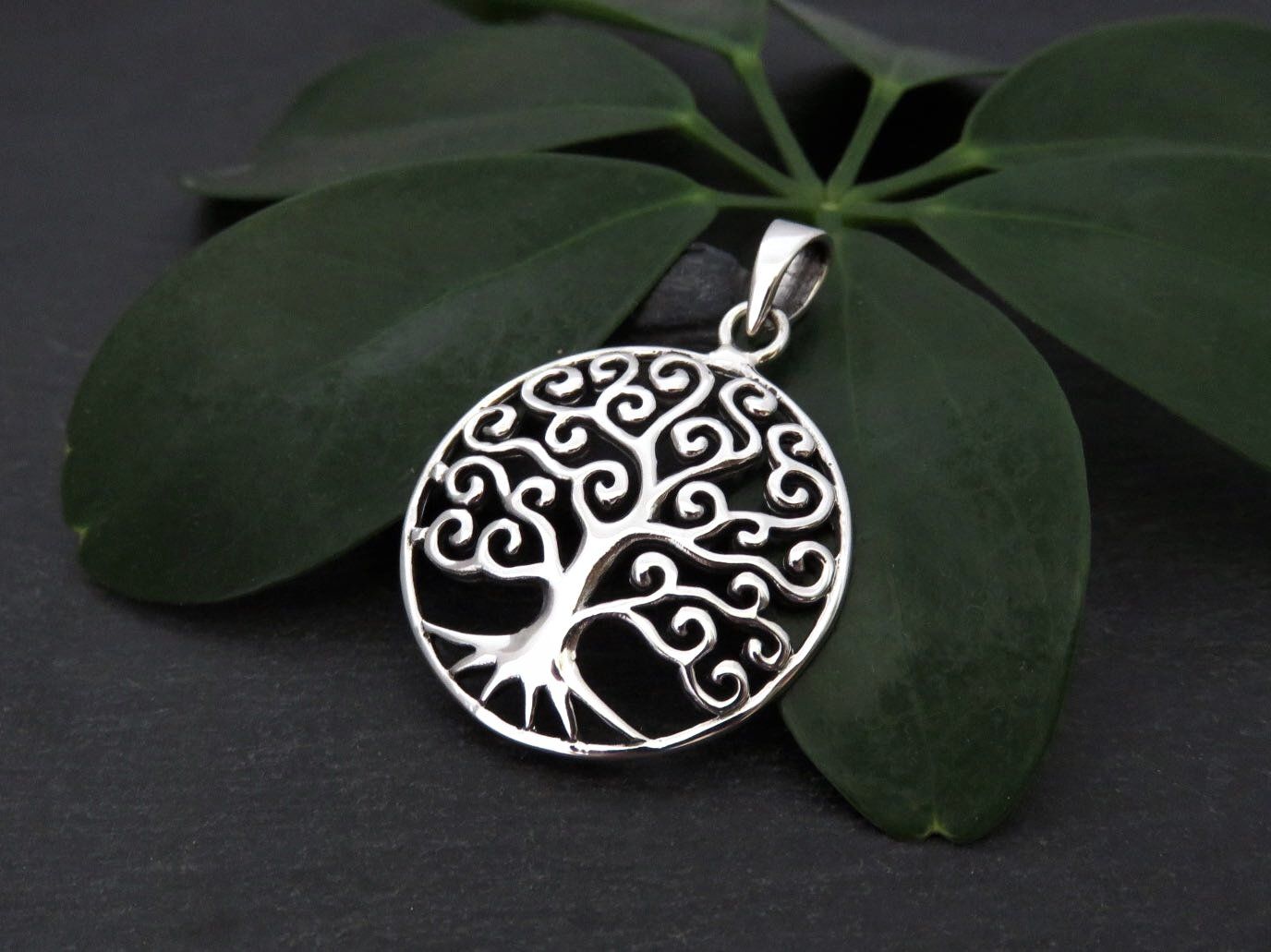 Domed pendant with the motif of the tree of life made of silver 