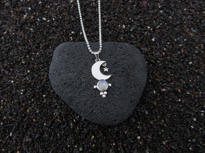 small pendant with moon and stars on a silver ball chain 