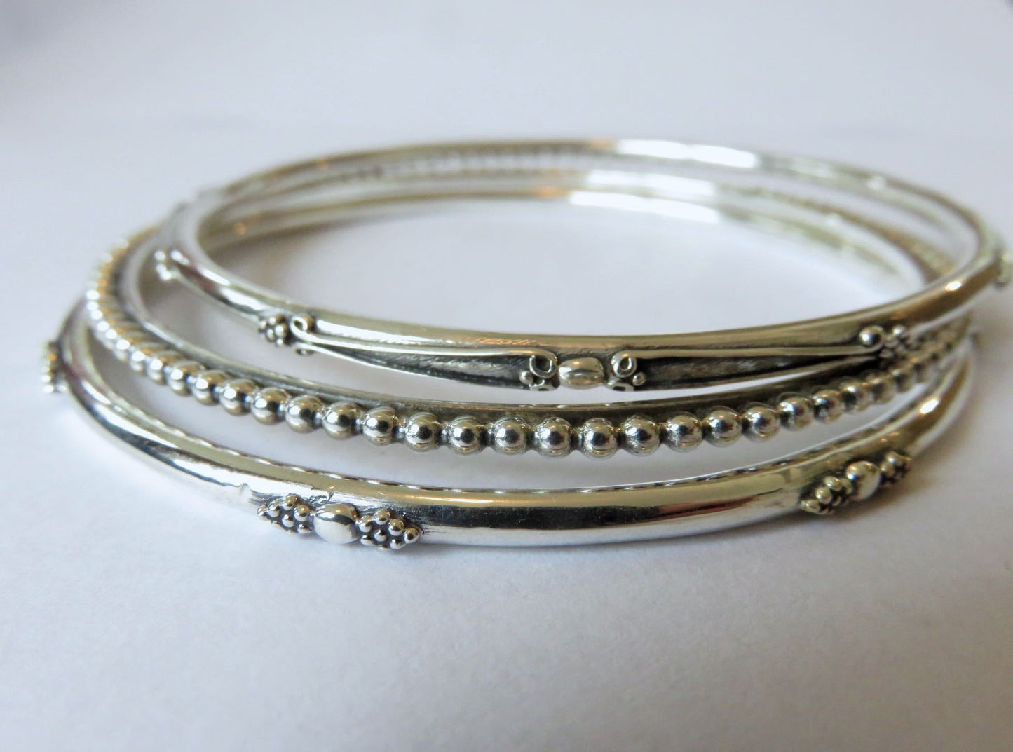 Set of three decorated silver bangles 