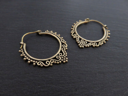 small hoop earrings decorated with spirals and dots made of brass 