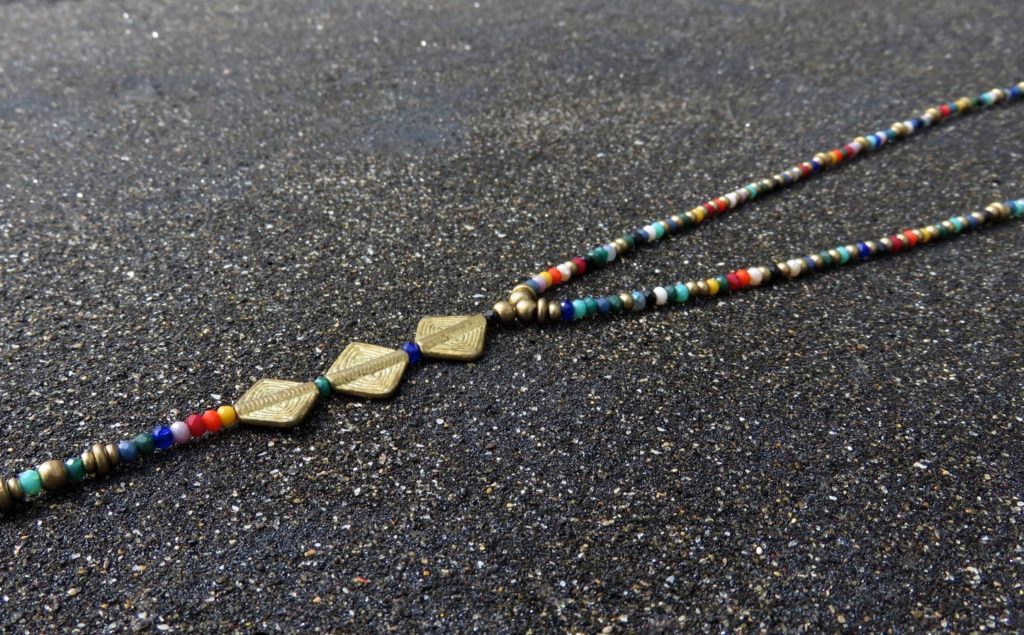 long necklace with faceted glass beads and brass elements 