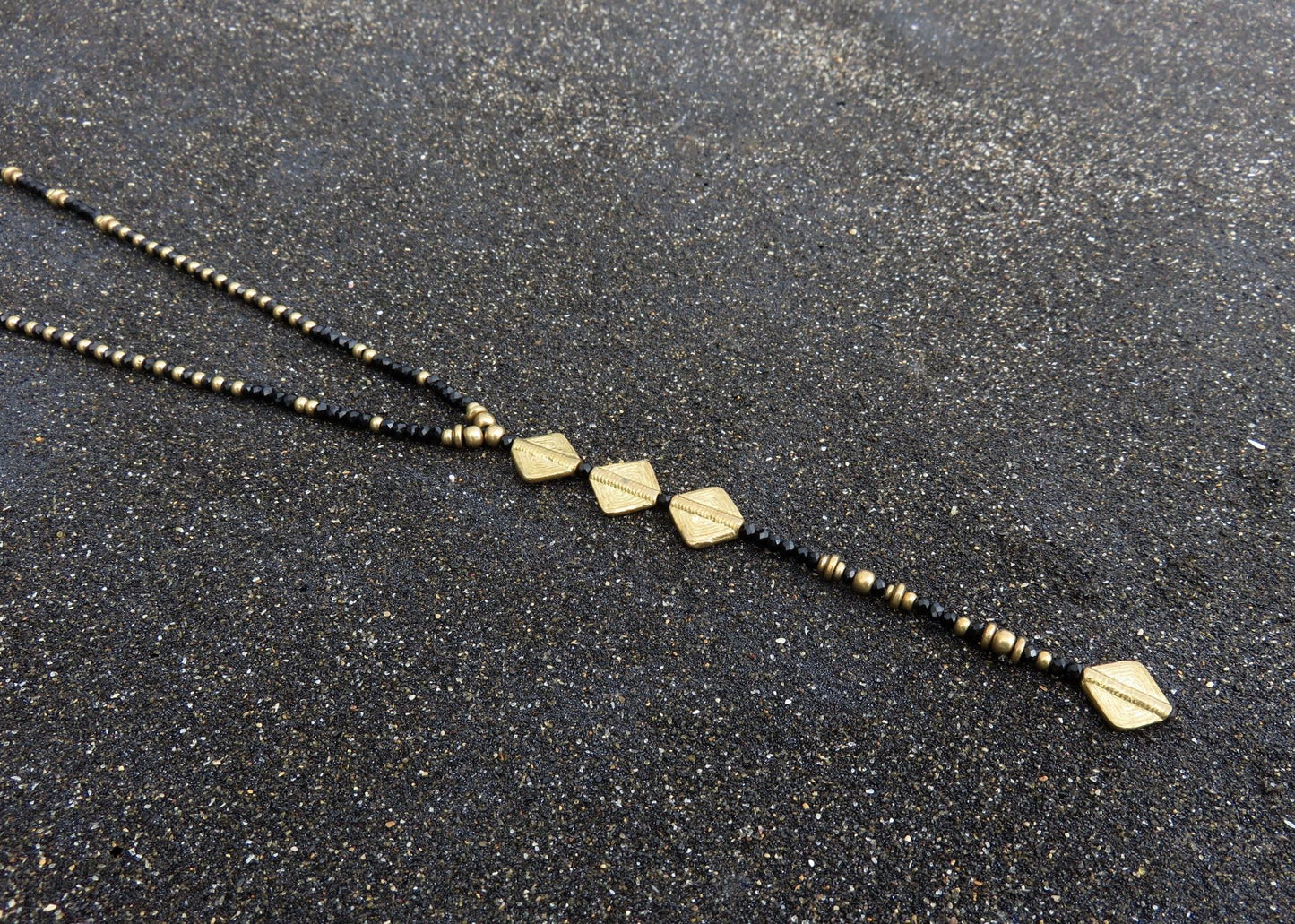 long necklace with faceted glass beads and brass elements 