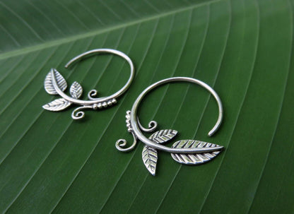 small hoop earrings with leaves and spirals made of silver 