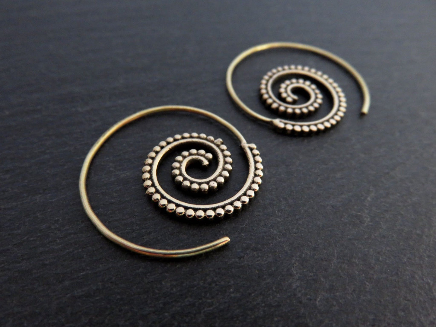 small spiral earrings with dot pattern made of brass 